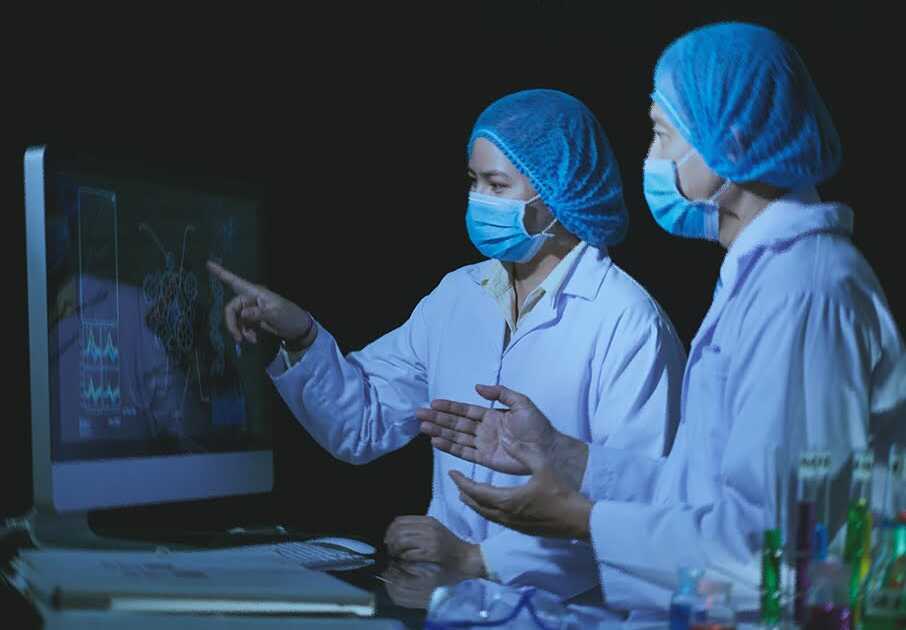 AI Pharma Researchers Analyzing Data on Computer Screen in Laboratory